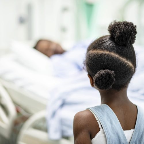 Daughter watching her grandmother sleep at the hospital